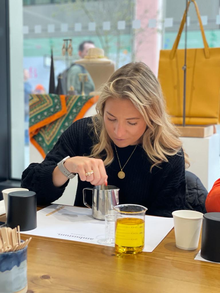 Lady making a candle at battersea power station during the ambustum candle making workshop